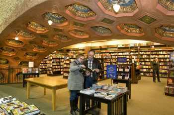 The theatre in use as a bookstore between 1994 and 2015, showing the fiction department framed by the theatre’s proscenium arch, courtesy <i>Post Bulletin</i> (JPG)