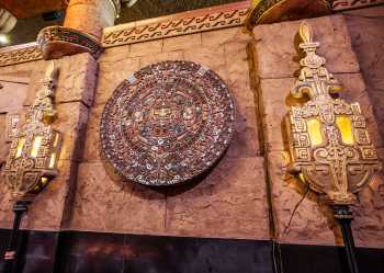 Sun Stone on lobby wall, flanked by heraldic lamp standards