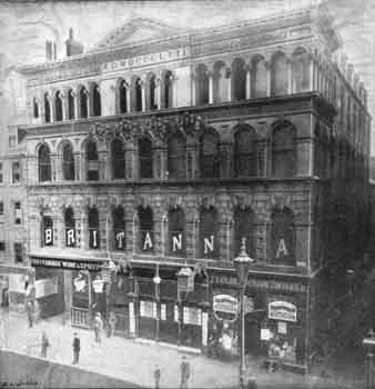 Exterior of the Britannia Building circa 1890. Note the large lamps on either side of the entrance to the pub/music hall (a traditional feature of such institutions) and also the sclupted putti high up on the façade (JPG)
