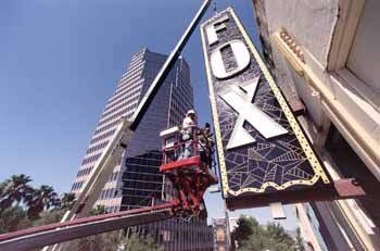 The theatre’s new vertical sign is installed by <i>Fluoresco Lighting & Signs</i>, as printed in the <i>Arizona Daily Star</i> in early 2002 – the sign was re-lit on 29th June 2002 (JPG)