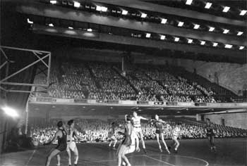 The USC Basketball team playing onstage at the Shrine Auditorium